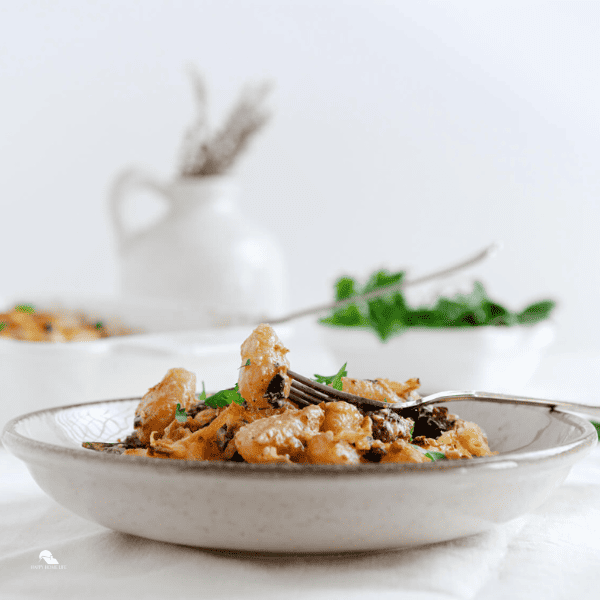 Baked Gnocchi on a white plate in square sized image