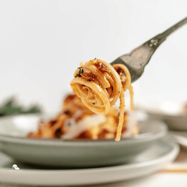 Browned Butter, Pumpkin, and Bacon Linguine being scooped by a fork
