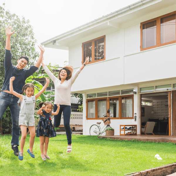 happy family in front of their new home