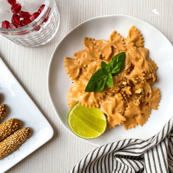 an image of Pasta with Roasted Red Pepper Walnut Sauce in a white plate