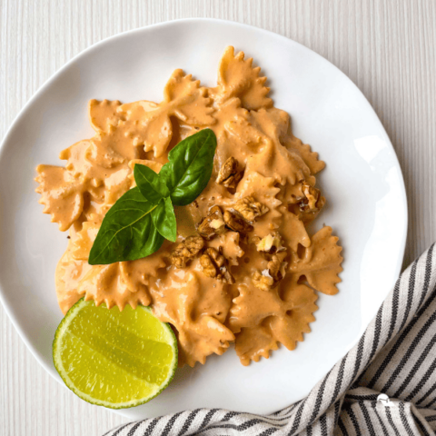 Pasta with Roasted Red Pepper Walnut Sauce in a white plate