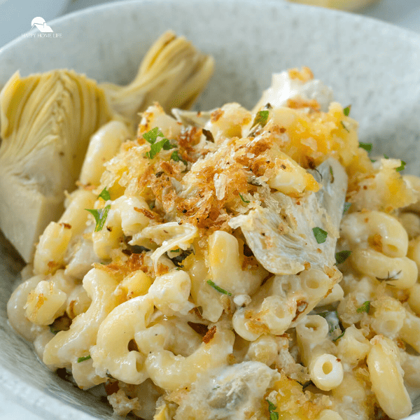 close up image of Spinach Artichoke Mac and Cheese in a white bowl