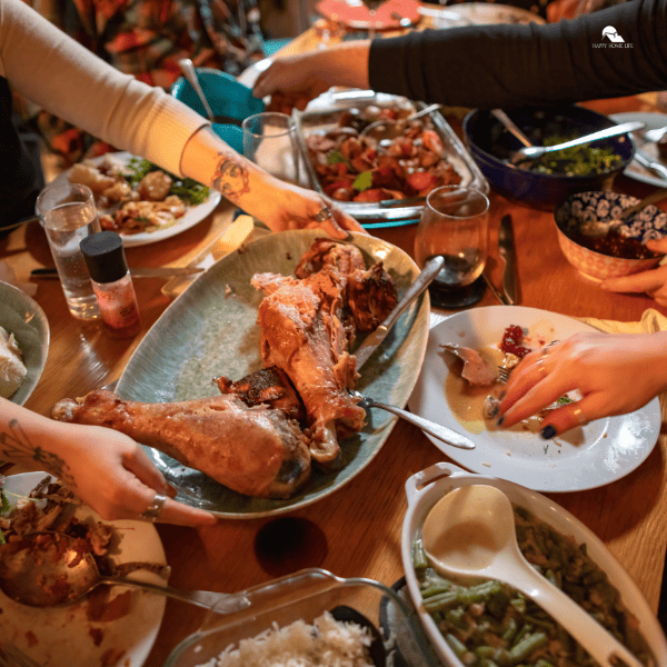 Group of people gathered around a table covered with food for a Friendsgiving dinner