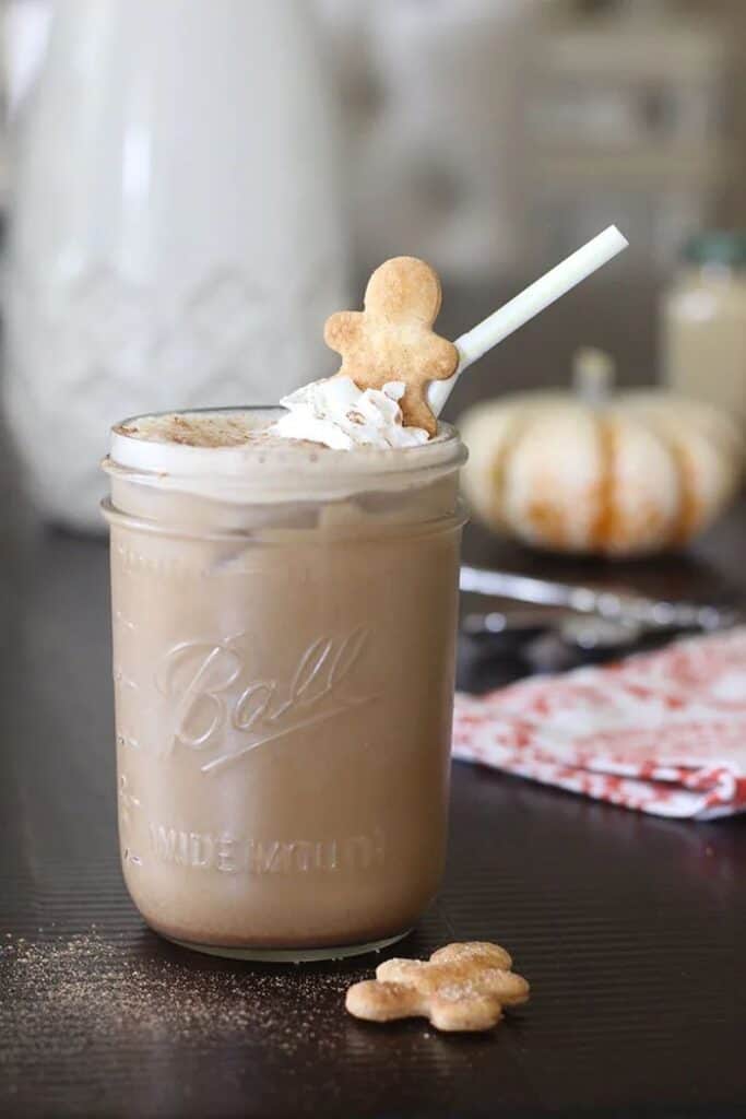 gingerbread iced coffee garnished with whipped cream and gingerbread cookie