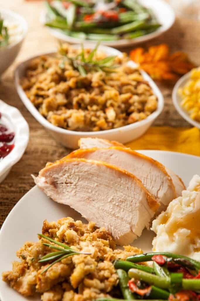 thanksgiving dinner on plate with dishes in background