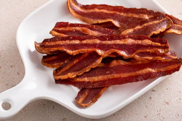 cooked turkey bacon on white serving dish