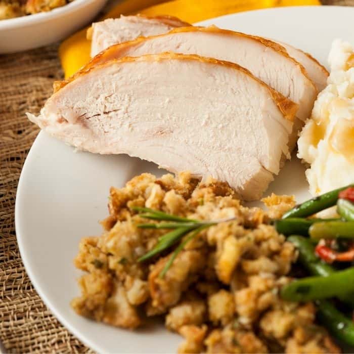 turkey breast on plate with stuffing