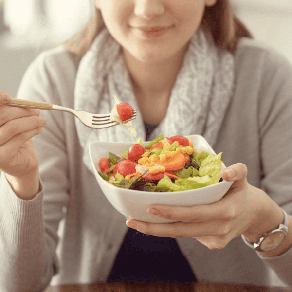 A lady eating salad
