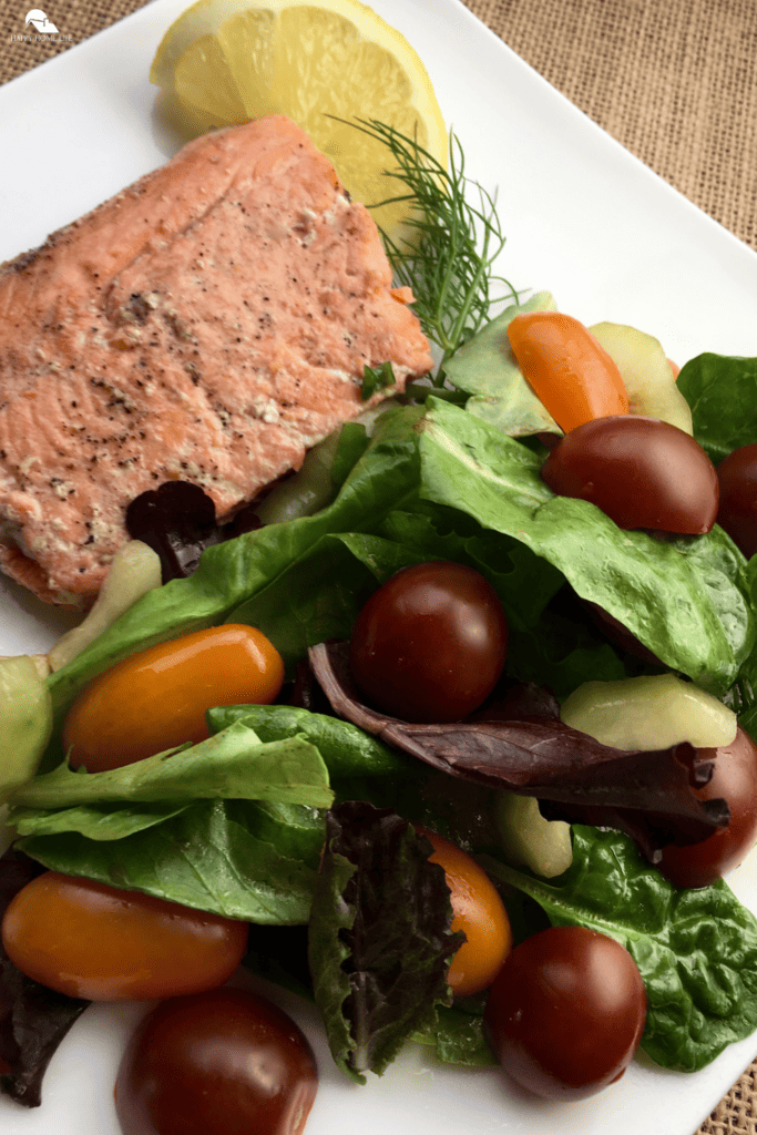 Lemon and Dill Salmon with Herb Salad in a white plate