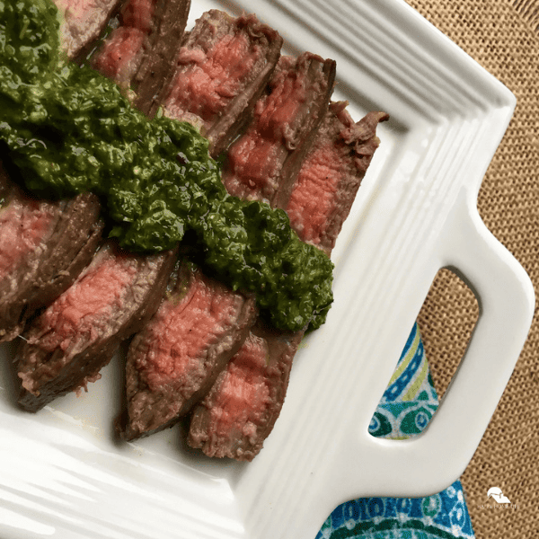 Marinated Flank Steak with Chimichurri Sauce in a white plate