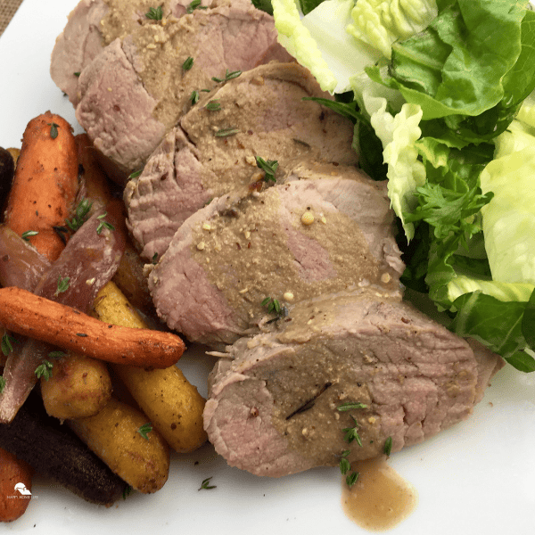 Mustard Pork Loin with Thyme-Roasted Carrots in a plate