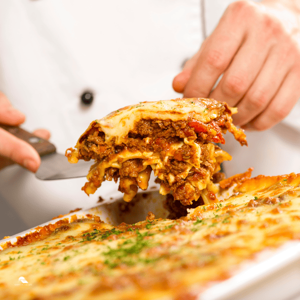 chef dishing up Lasagna