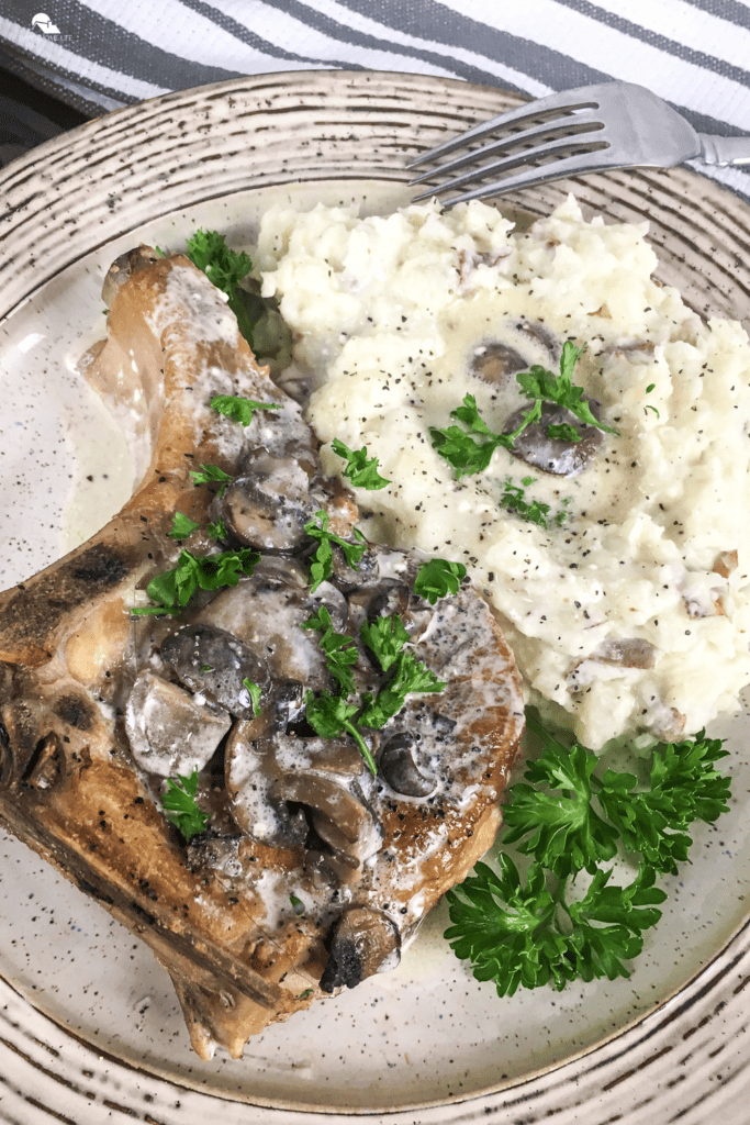 Slow Cooker Thick-Cut Bone-In Pork Chops in a plate