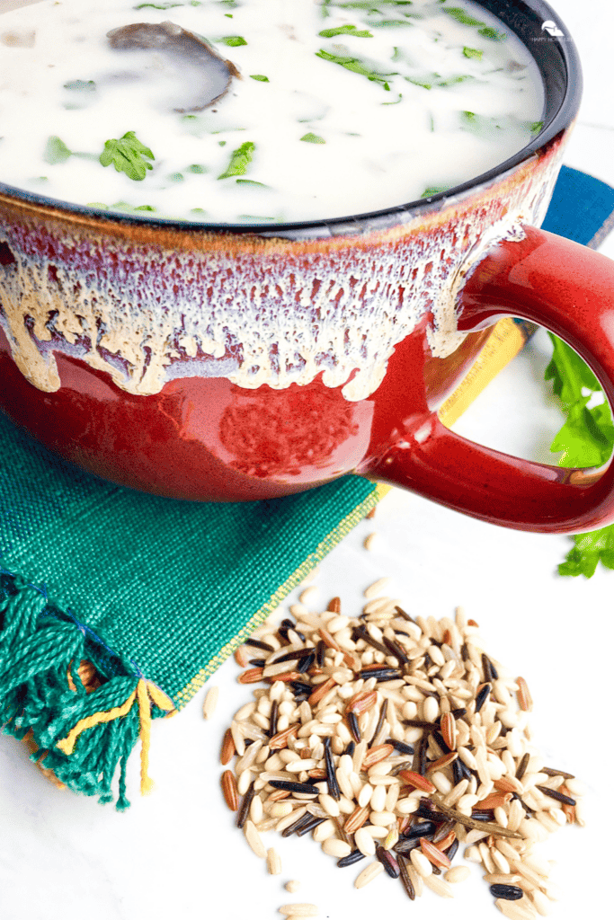 pin sized image of Creamy Wild Rice and Mushroom Soup in a red cup