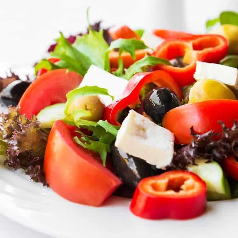 close up of mediterranean salad with tomatoes, olives, and more