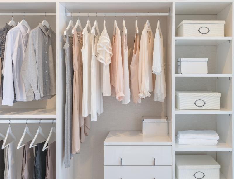 organized closet with clothes and boxes inside