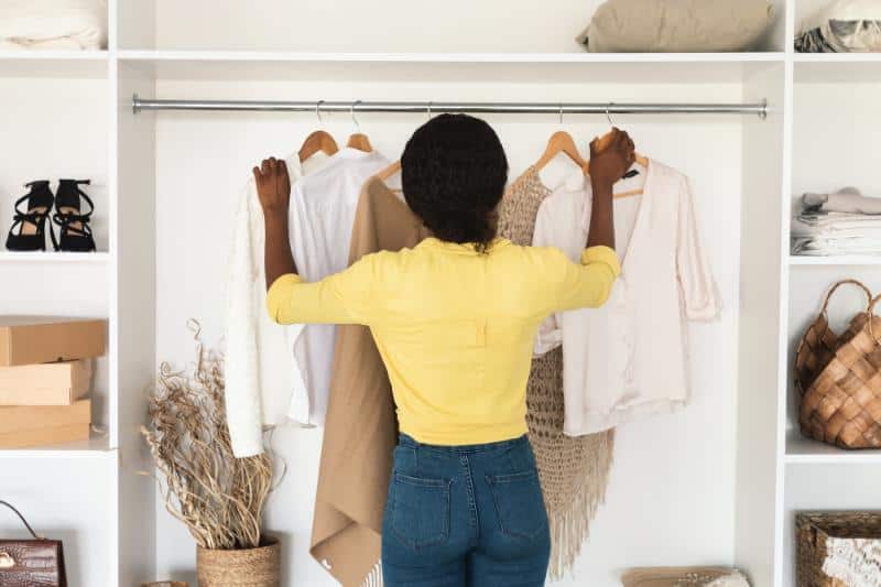 woman picking out clothes to wear