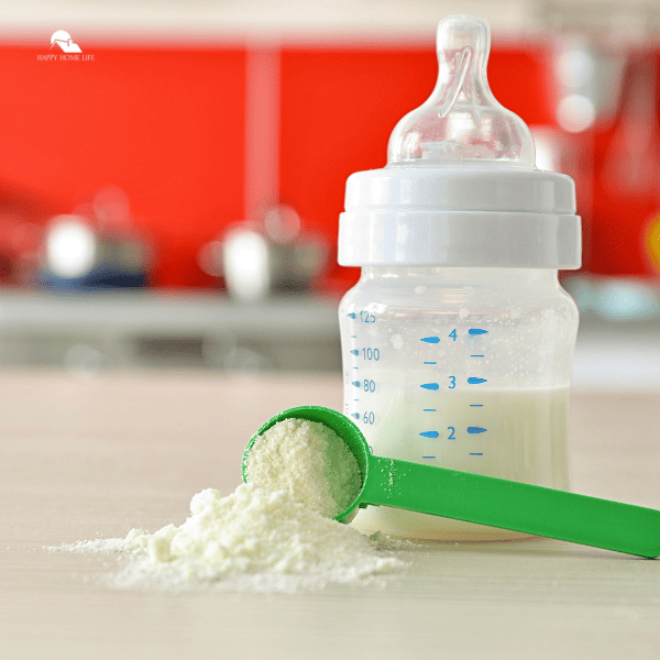 Feeding Bottle and Baby Milk Formula on Kitchen Background