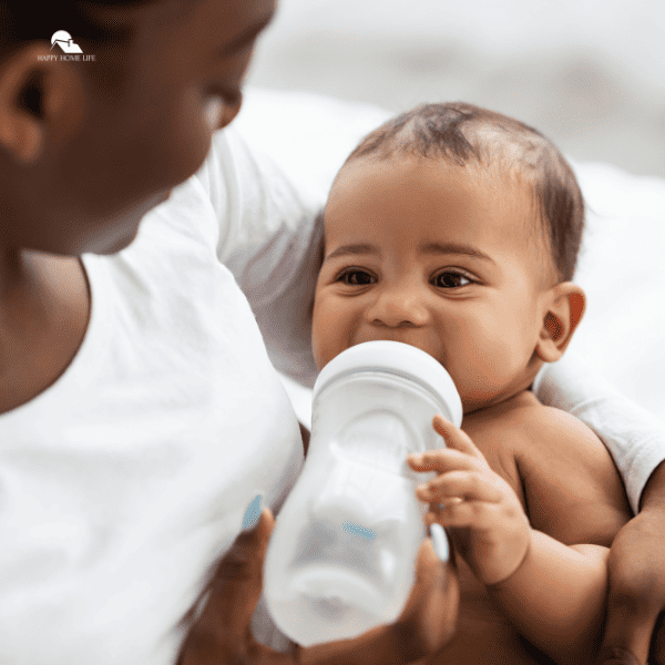 woman feeding her child from baby bottle