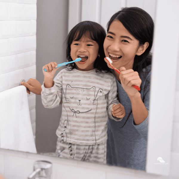 mom and daughter brushing teeth 