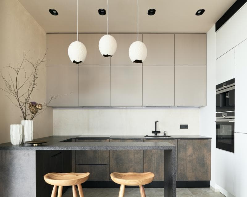 modern kitchen with granite bar and 2 stools