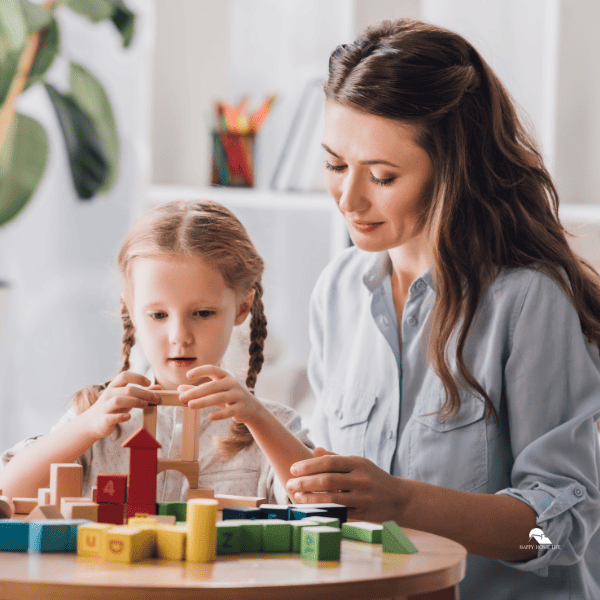 mom playing blocks with little child with autism syndrome
