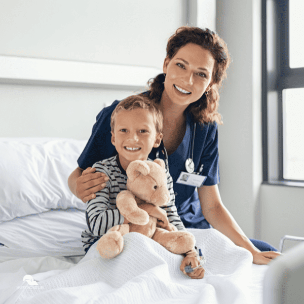 Happy Nurse with Smiling Kid at Hospital