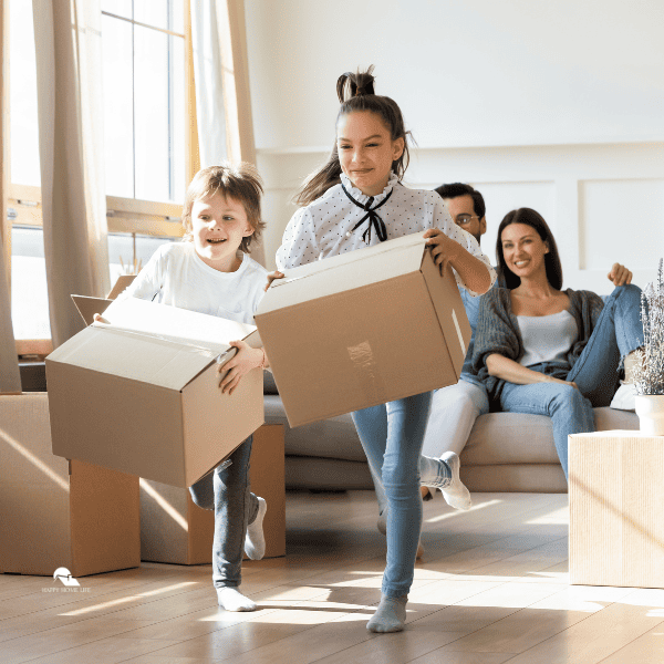Excited kids have fun unpacking boxes on moving day
