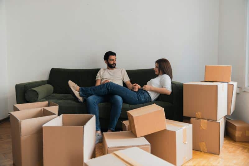 couple on couch surrounded by boxes