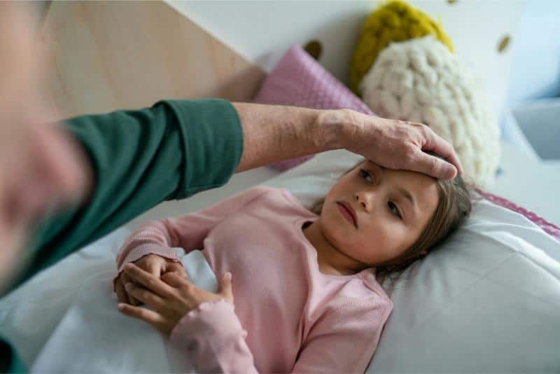 grandmother feeling sick child's forehead