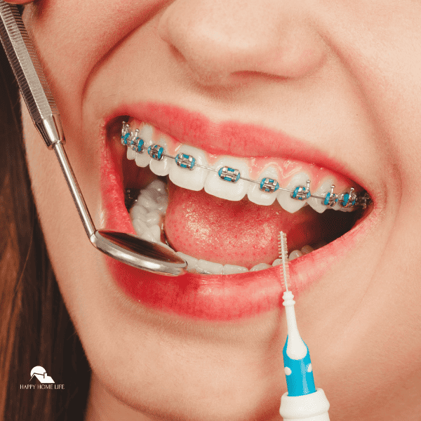 Woman smiling cleaning teeth with braces