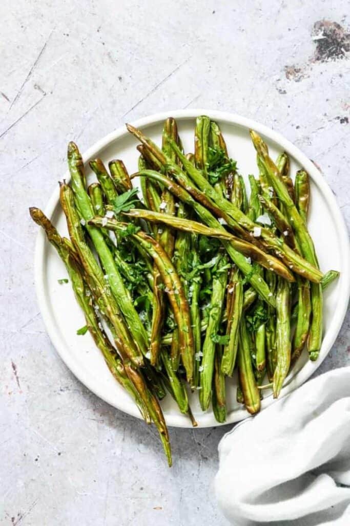 crispy air fryer green beans on white plate