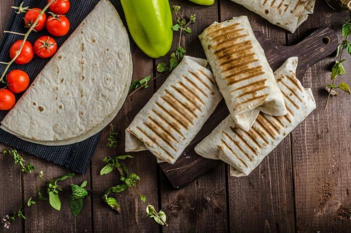 breakfast burritos on dark wooden background