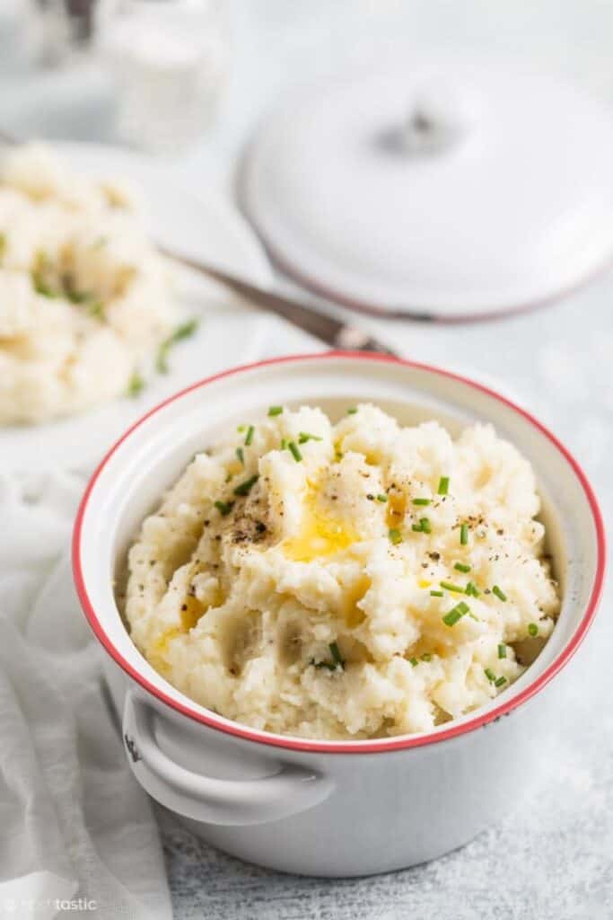 cauliflower mashed potatoes in white bowl with red rim