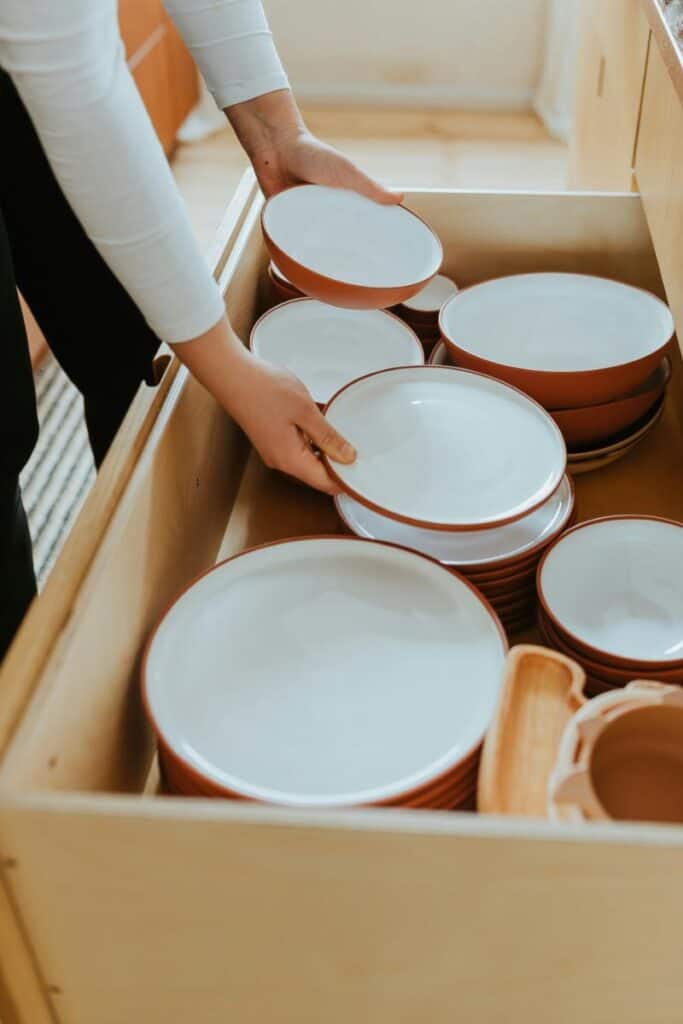 dishes stored in a large drawer instead of a cabinet