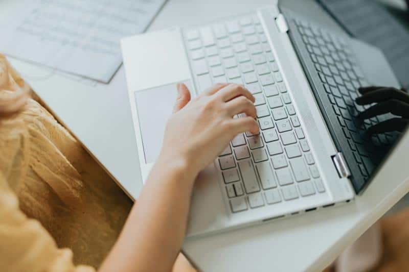 hand typing on laptop