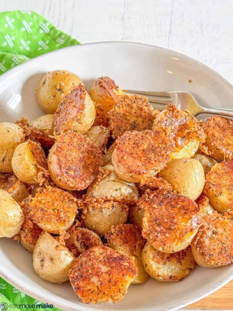 parmesan roasted baby potatoes in a shallow white bowl