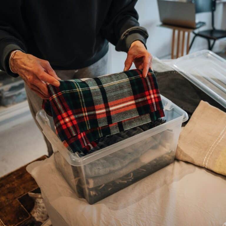 storing blankets or cloth in a plastic storage bin