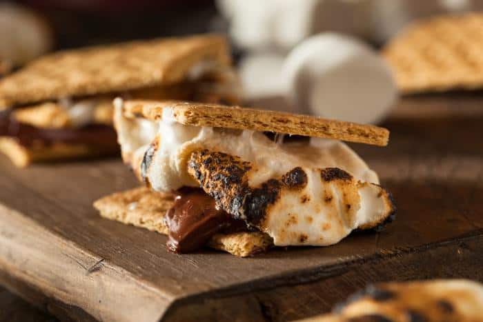 smores with toasted marshmallow and melted chocolate between the graham crackers - close up