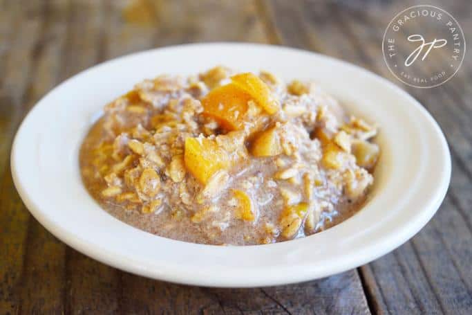 apricot overnight oats in white bowl on wooden table