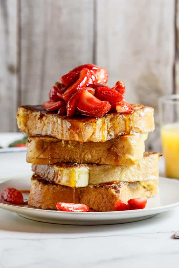 lemon french toast topped with fresh strawberries and syrup