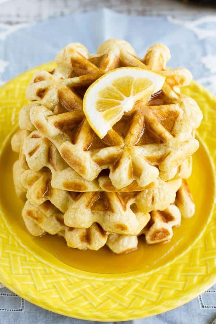 stack of lemon waffles on yellow plate