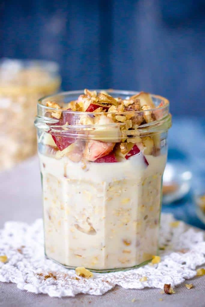 peach overnight oats in jar topped with granola and strawberries