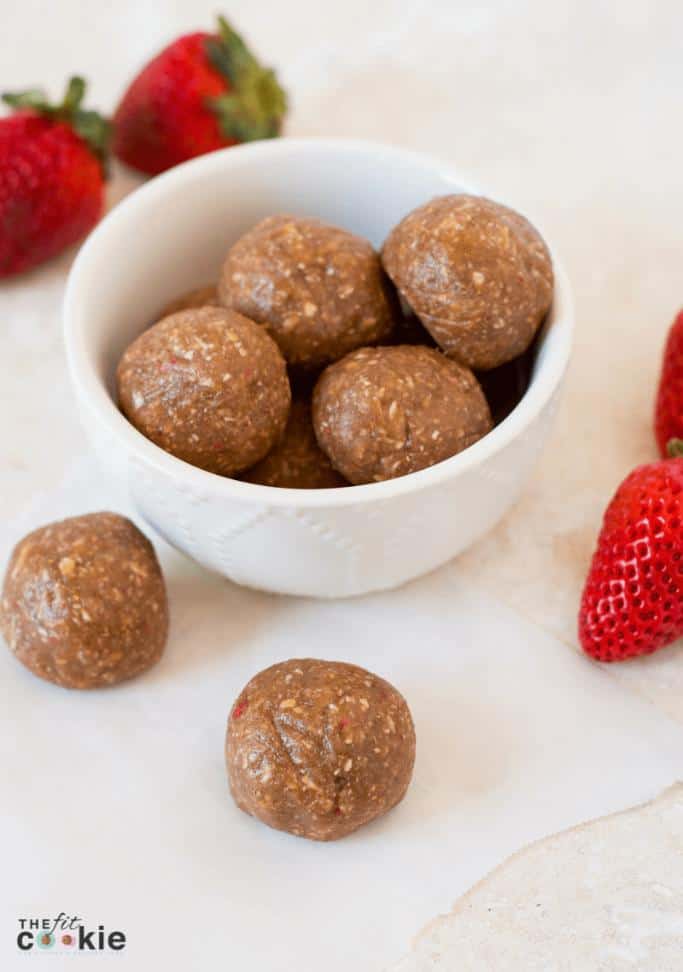 strawberry protein balls in a white bowl