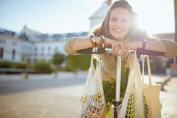 woman on bike with reusable shopping bags