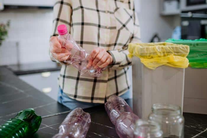 woman recycling plastic bottles
