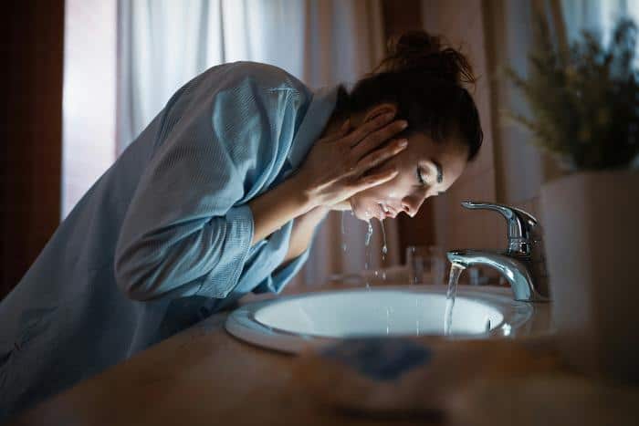 woman washing her face