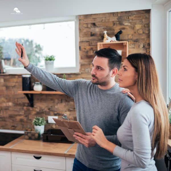 Couple talking about home renovation. Standing in the kitchen and discussing apartment renovation ideas.