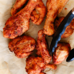 Golden, crispy homemade fried chicken pieces resting on parchment paper, showing crunchy texture and perfect browning for an easy fried chicken recipe made from scratch.
